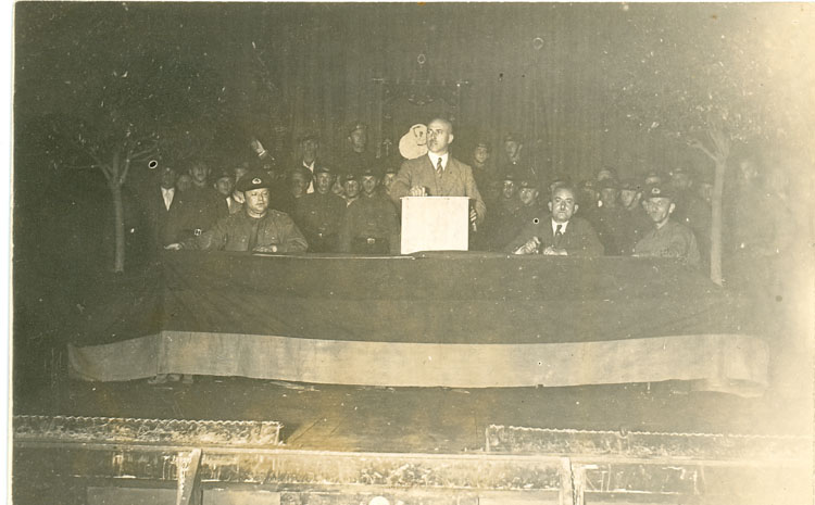 Wilhelm Leuschner am Rednerpult auf einer Wahlveranstaltung mit dem Reichsbanner Schwarz-Rot-Gold, 1929